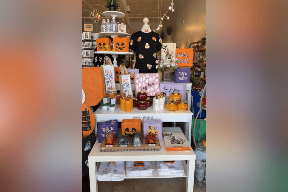 Tabletop display of unique Christmas gifts, candles, stationery, and home goods inside Adelyne’s Boutique, a top Tomball destination for holiday shopping.