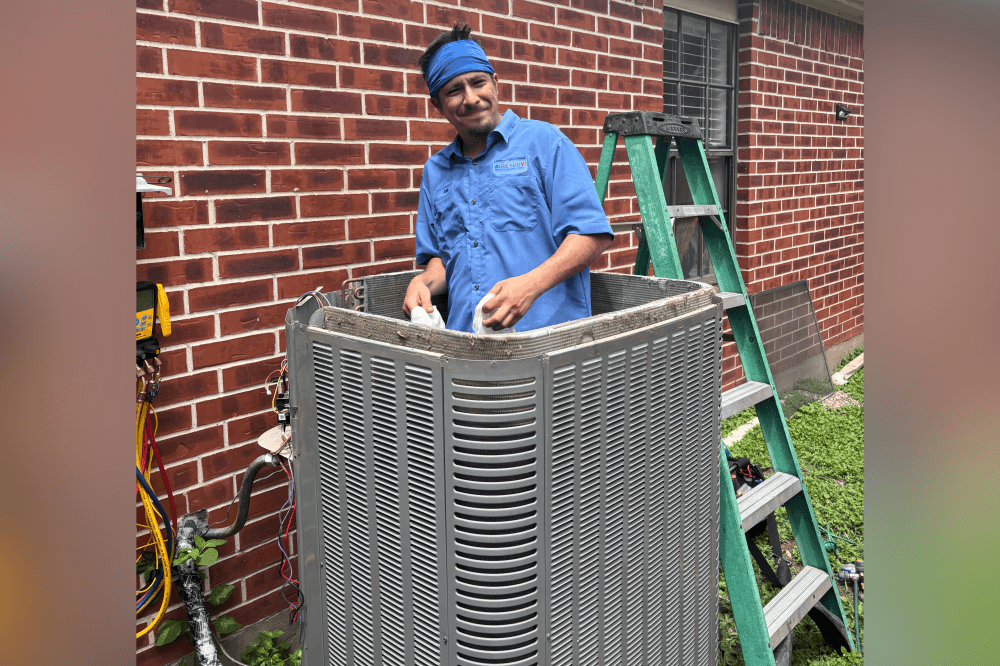 Aire Serv of Houston Northwest technician performing HVAC maintenance on a home heating system in Houston to ensure energy efficiency and comfort.