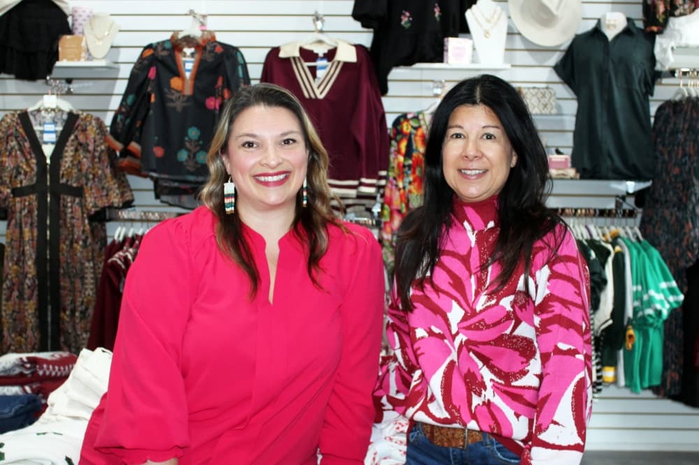 Two females in a retail clothing store. 