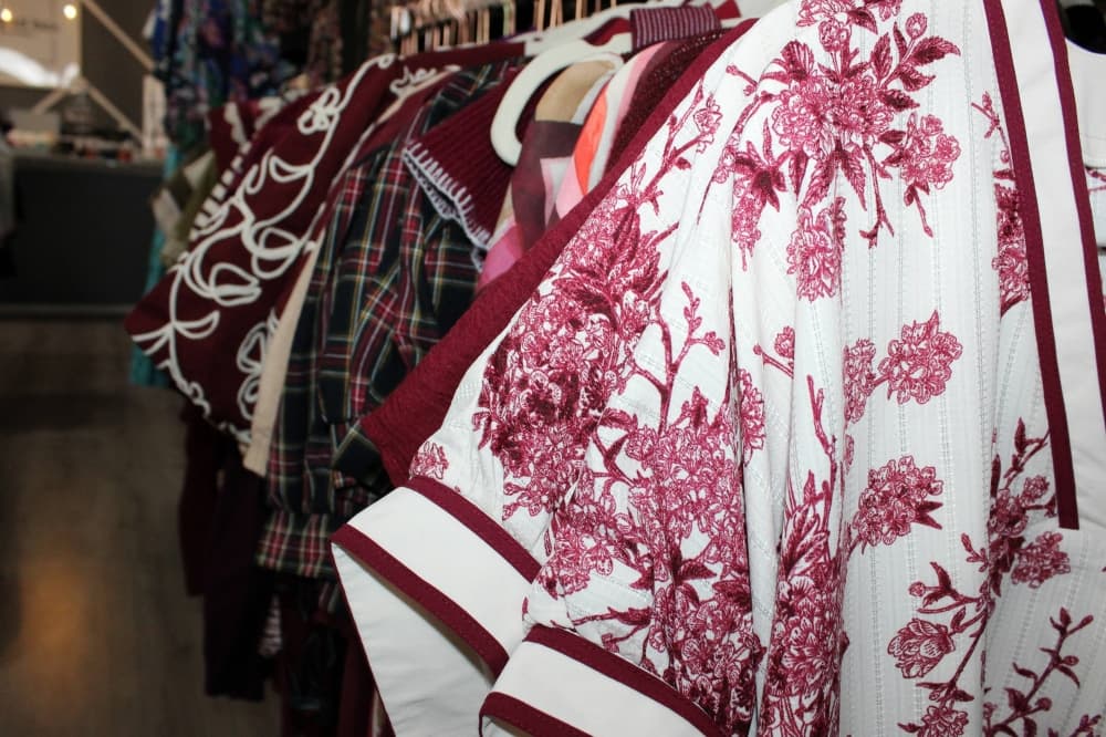 Tops featuring shades of burgundy on display in a store. 