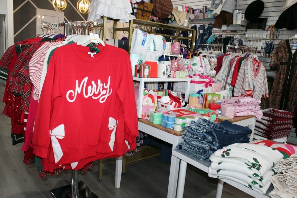 Christmas clothing and merchandise displayed in a store. 