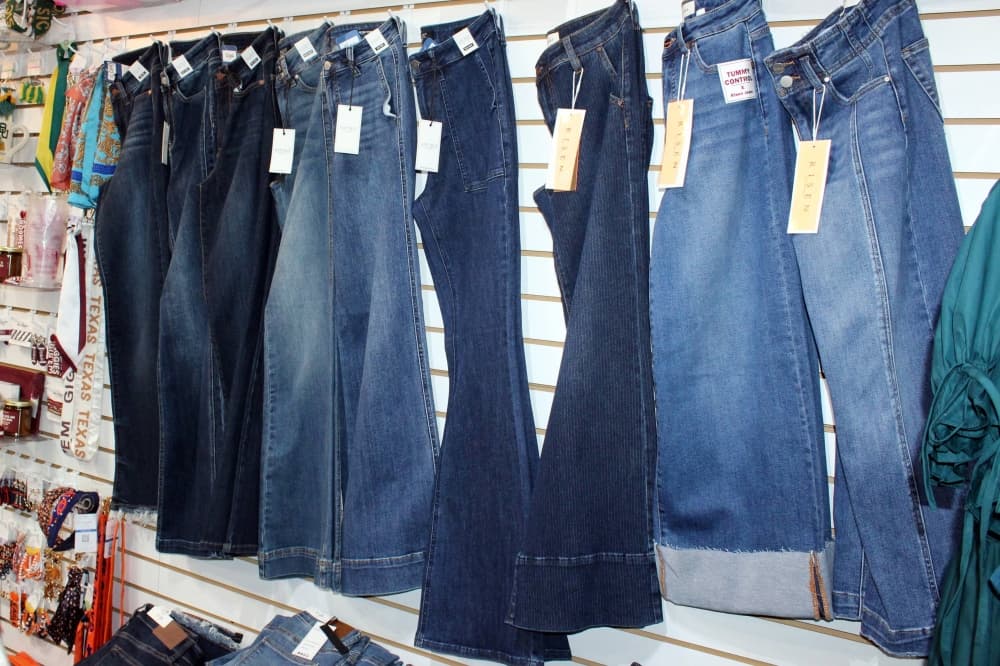 Jeans on display on a wall in a store. 