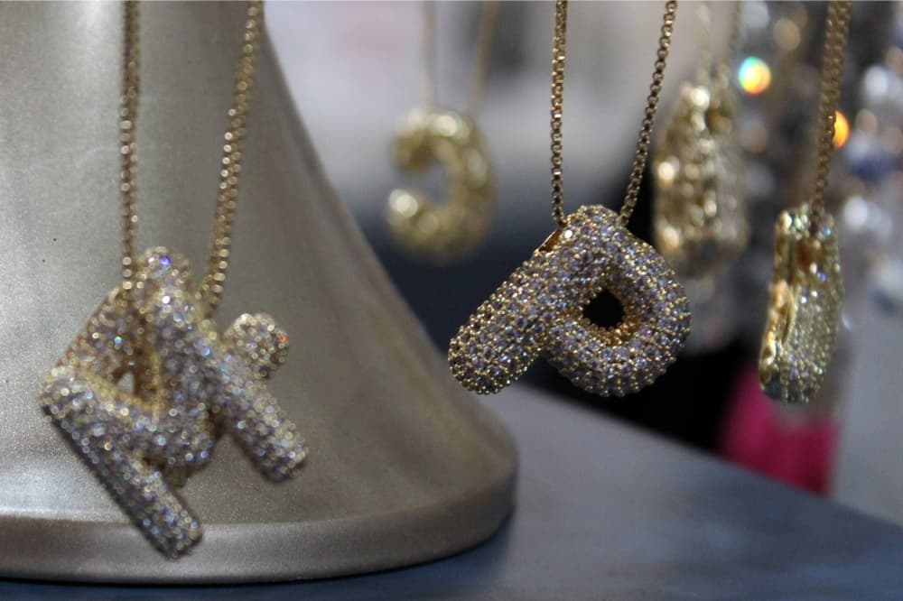 Necklaces featuring letters displayed in a store. 