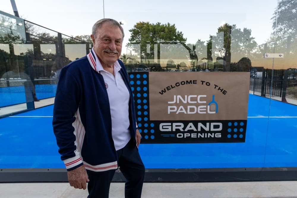 Australian tennis legend John Newcombe stands before his country club's newest padel ball courts.