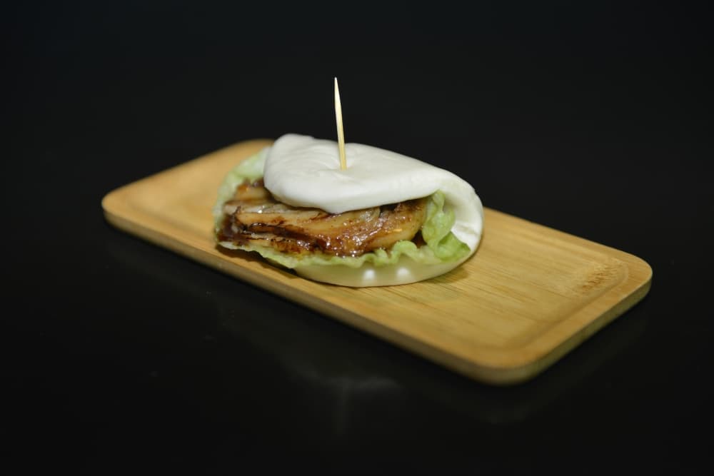 Pork chashu bun at Taro Japanese Restaurant in Houston, featuring tender pork, fresh vegetables, and traditional Japanese flavors near NRG stadium. 