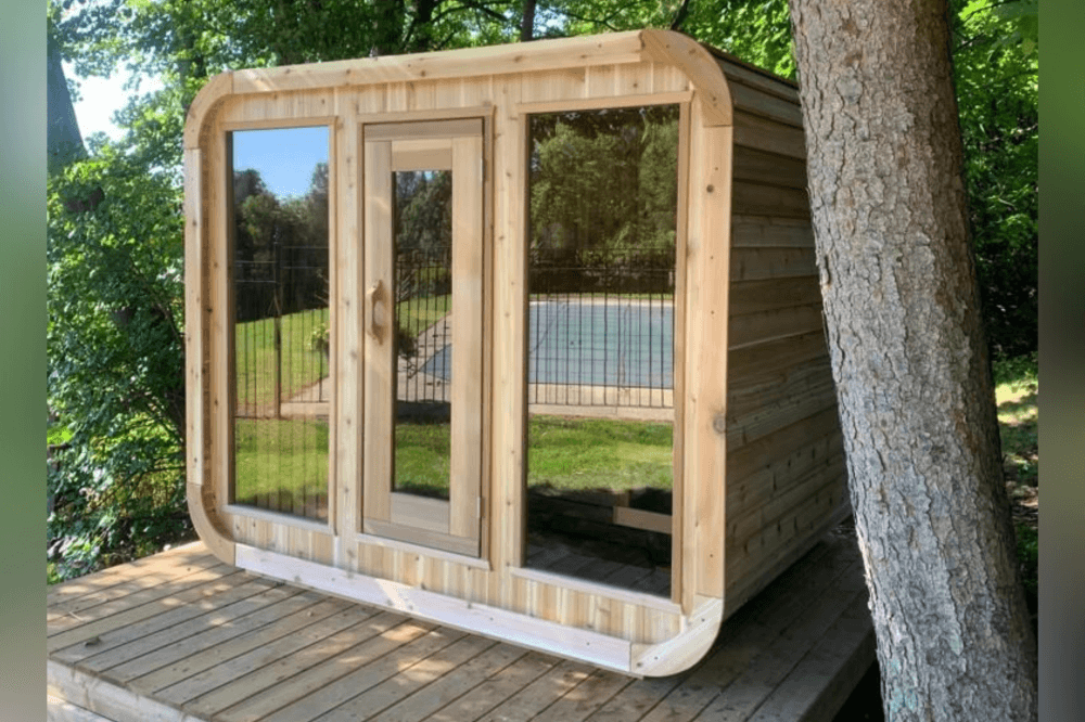 Outdoor sauna installation in Greater Houston with wood-burning heat, modern cube-style design, and app-controlled temperature for a luxury wellness retreat at home.