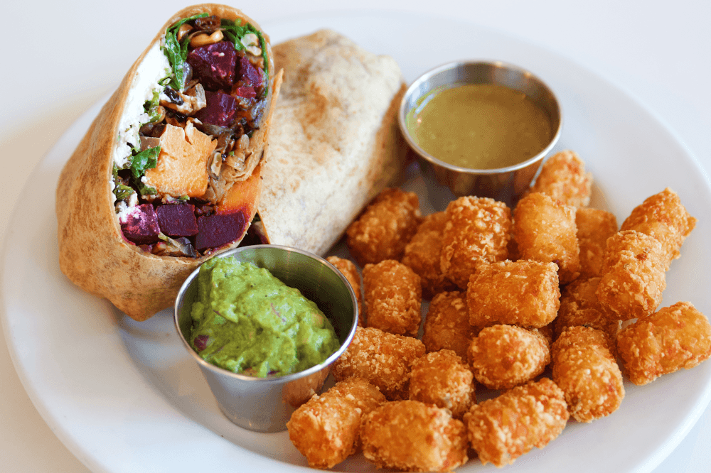 Smoked Beet Wrap served with sweet potato fries from Phoebe’s Diner in Austin, Texas — a gluten-free, flavorful wrap with smoked red beets, arugula, mushrooms, corn, onions, sweet potato, goat cheese, guacamole, and poblano vinaigrette in a BBQ tortilla, a top choice for Austin brunch and comfort food lovers.