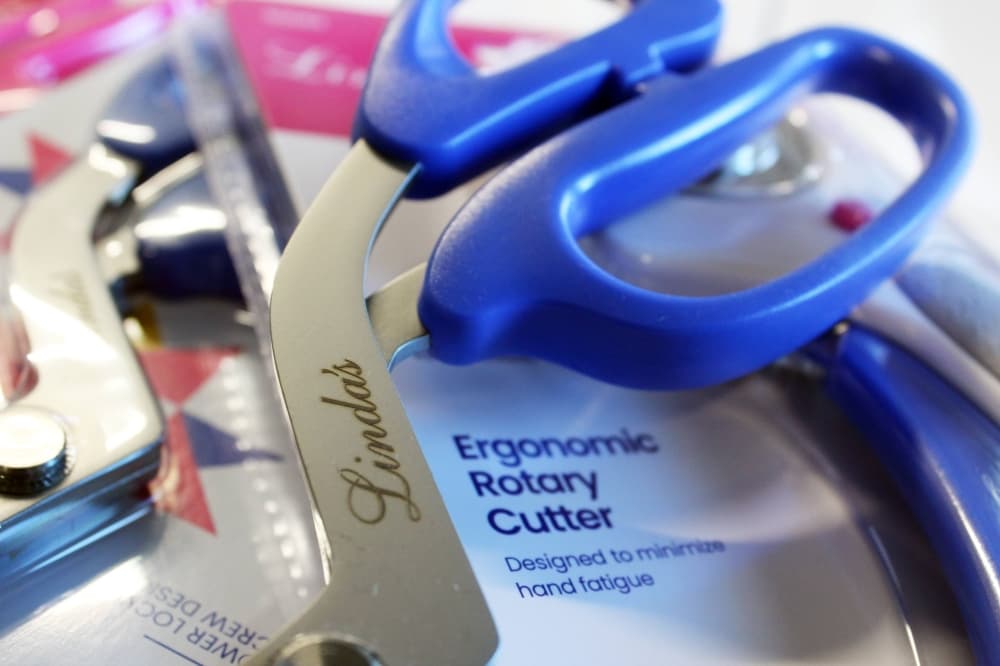 Scissors with Linda's engraved in cursive on the blade. 