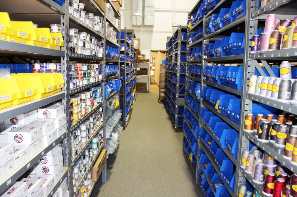 Warehouse space featuring metal shelves with bins. 