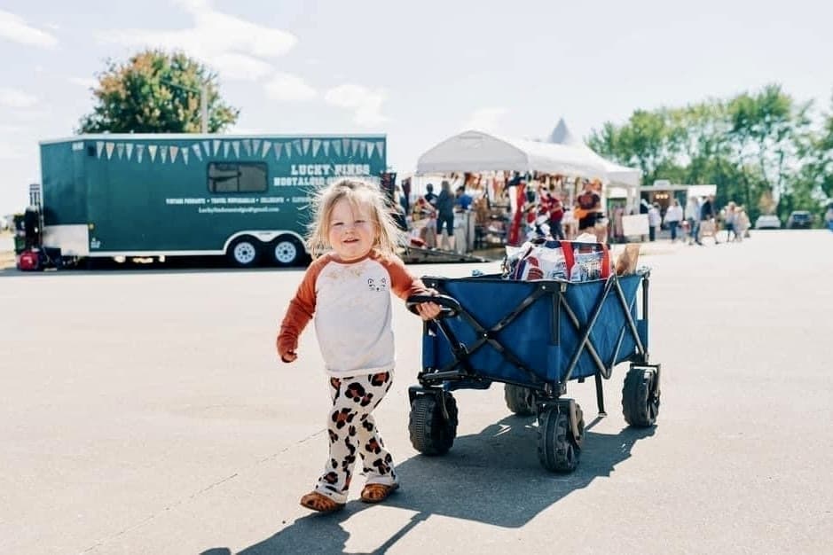 a child pulls a wagon in a parking lot