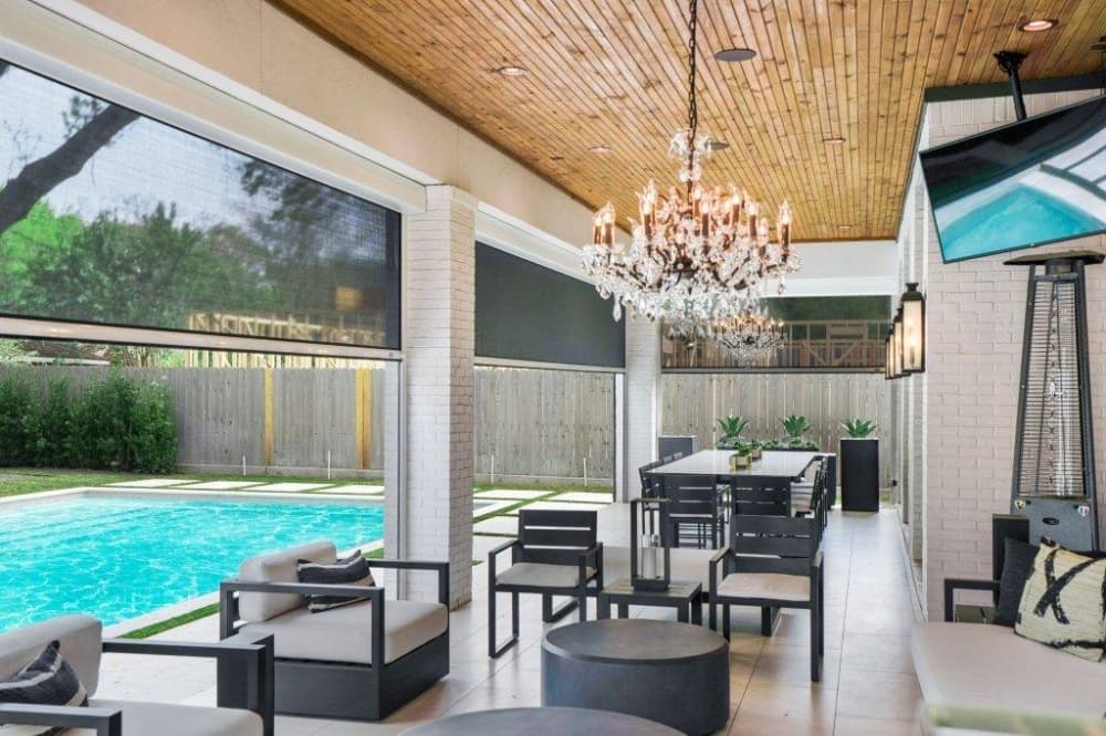 Patio next to a pool featuring retractable screens. 