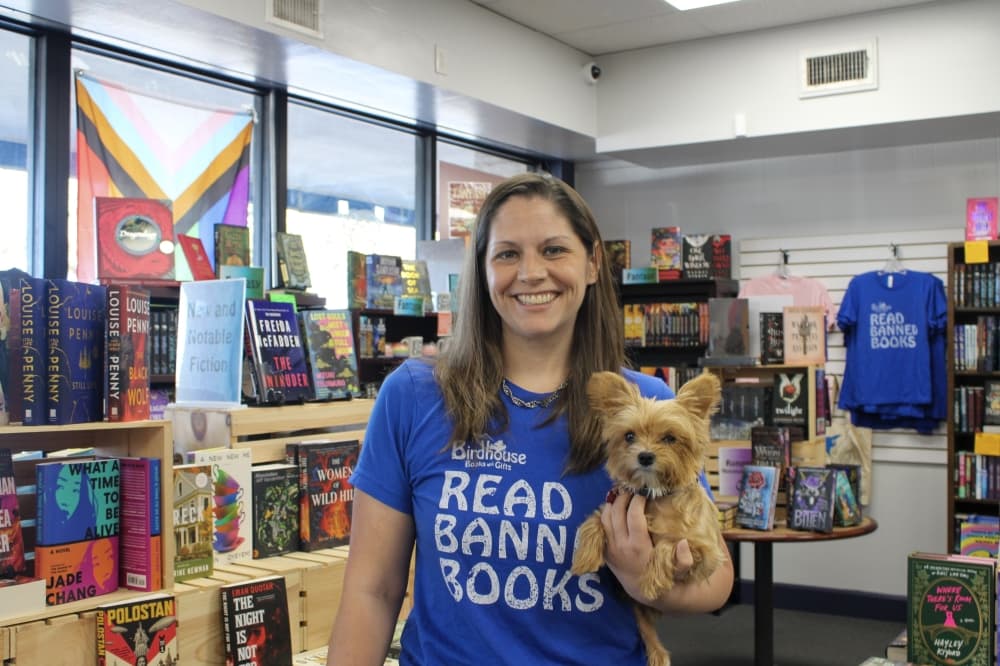 An image of the owner of the store and the store dog. 