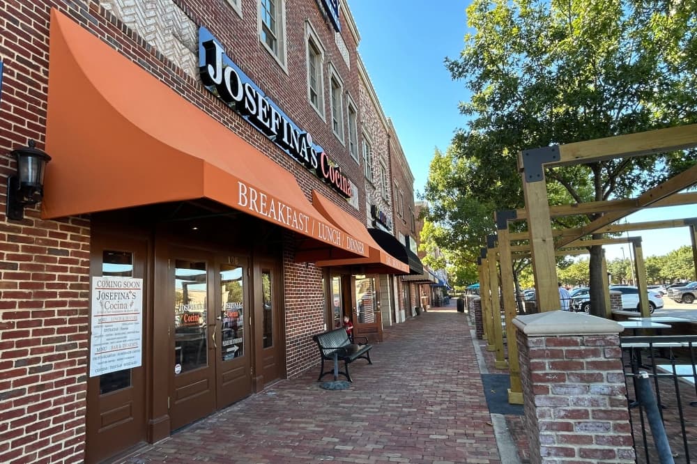 Exterior of a restaurant in a strip center featuring an orange awning and Josefina's Cocina signage. 