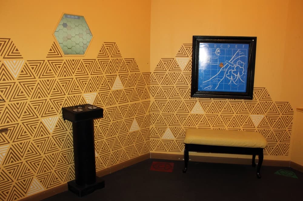 Room featuring orange walls with honeycomb illustrations. 