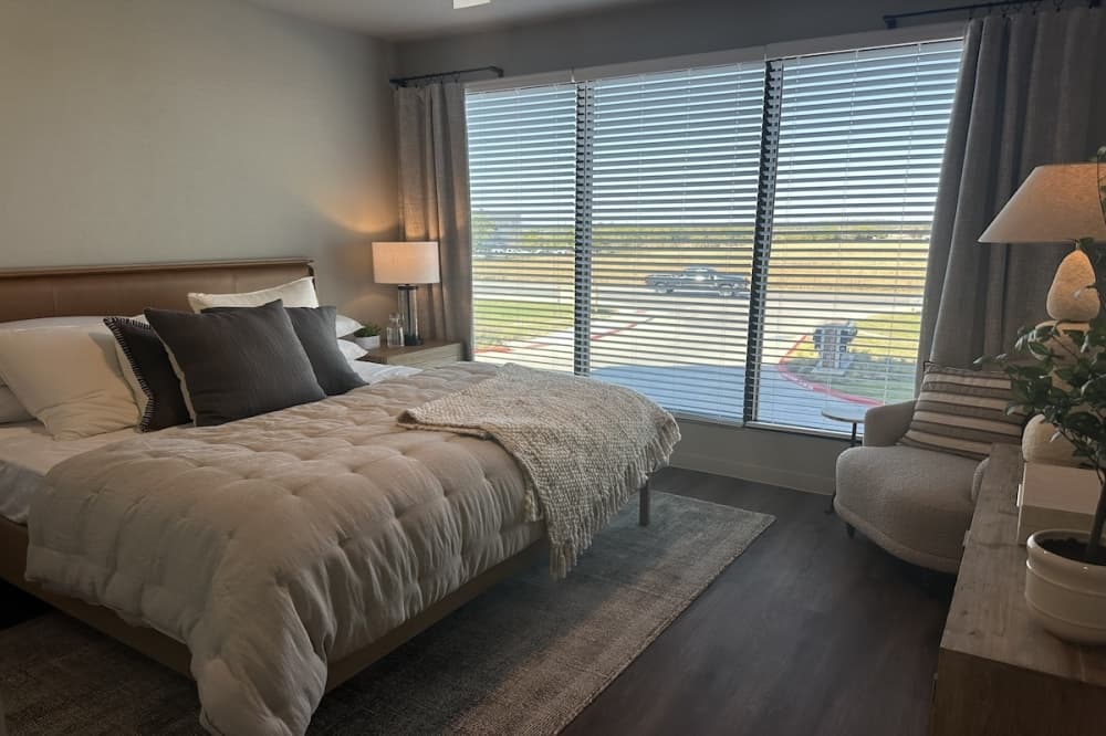 bedroom with a large window on one wall
