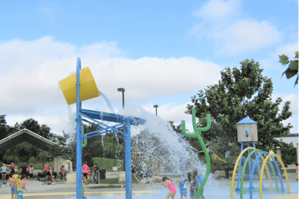 People enjoying the outdoors at a New Braunfels park — part of the city’s expanding, award-winning park system in Central Texas