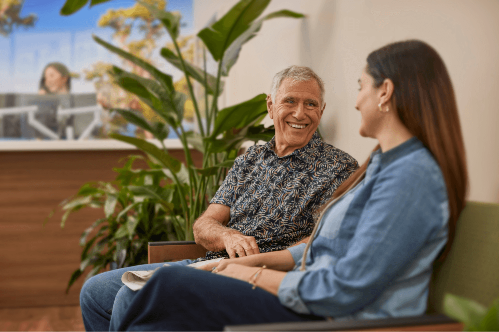 Seniors discussing Medicare plans during Annual Enrollment Period at Village Medical event