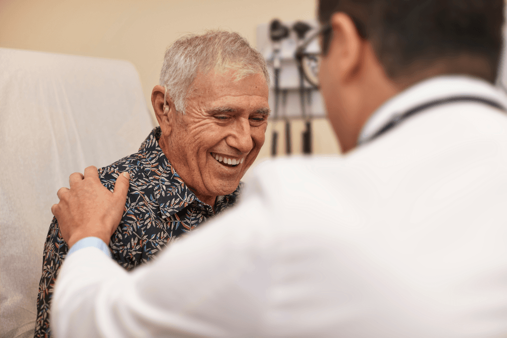 Doctor explaining Medicare plan options and coverage changes to elderly patients