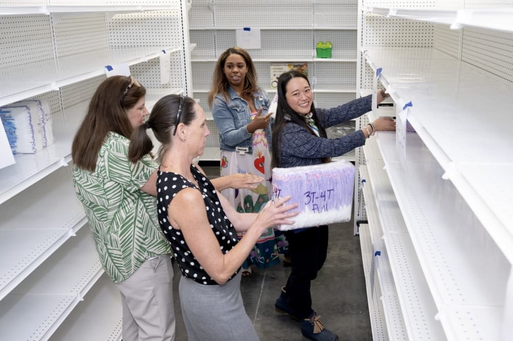 women stocking shelves