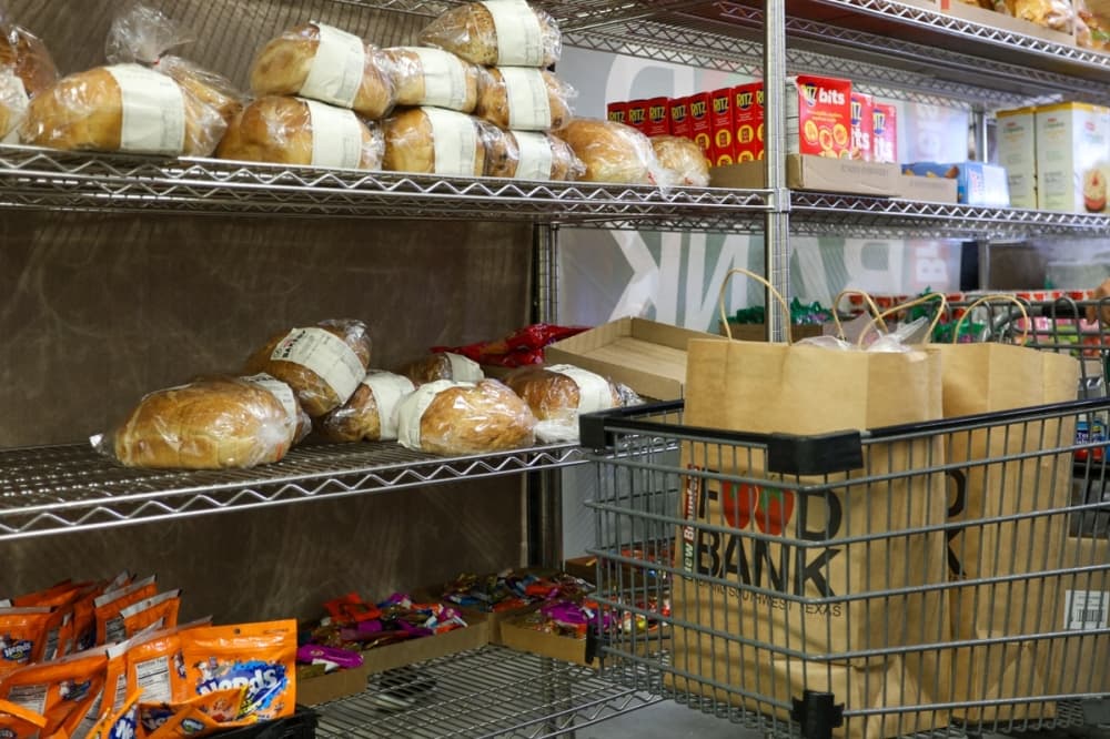 Shoppers at The Kitchen Table can receive assistance catered to their needs, choosing items from shelves stocked with canned goods, proteins, dairy and sweets. (Ethan Thomas/Community Impact)