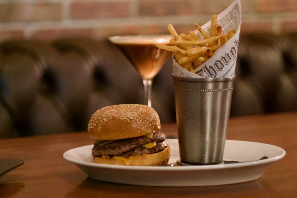 Volstead's cheeseburger ($18) is made with two beef patties, American cheese, pickles and minced onions. (Adam Doe/Community Impact)