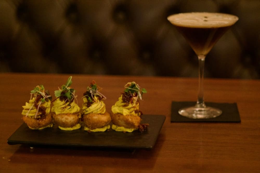 The crispy deviled eggs ($13) are garnished with sweet jalapeno relish and crispy prosciutto. (Adam Doe/Community Impact)