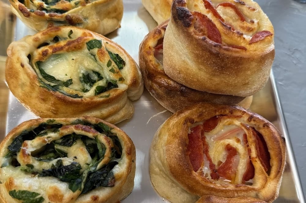 Different types of calzones on a tray. 