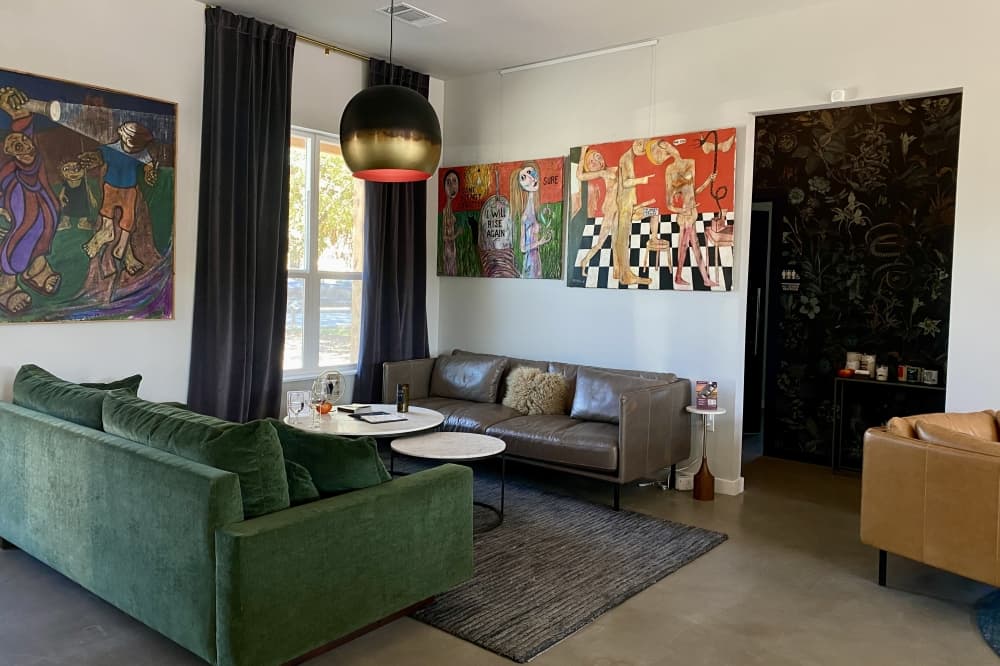 The interior of Swallow Wines features over 50 years of paintings by Don Snell. The paintings are on rotation and are also available for purchase. (Katlynn Fox/Community Impact)