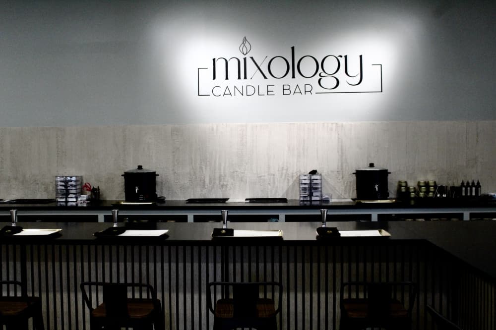 candle bar with logo in the background