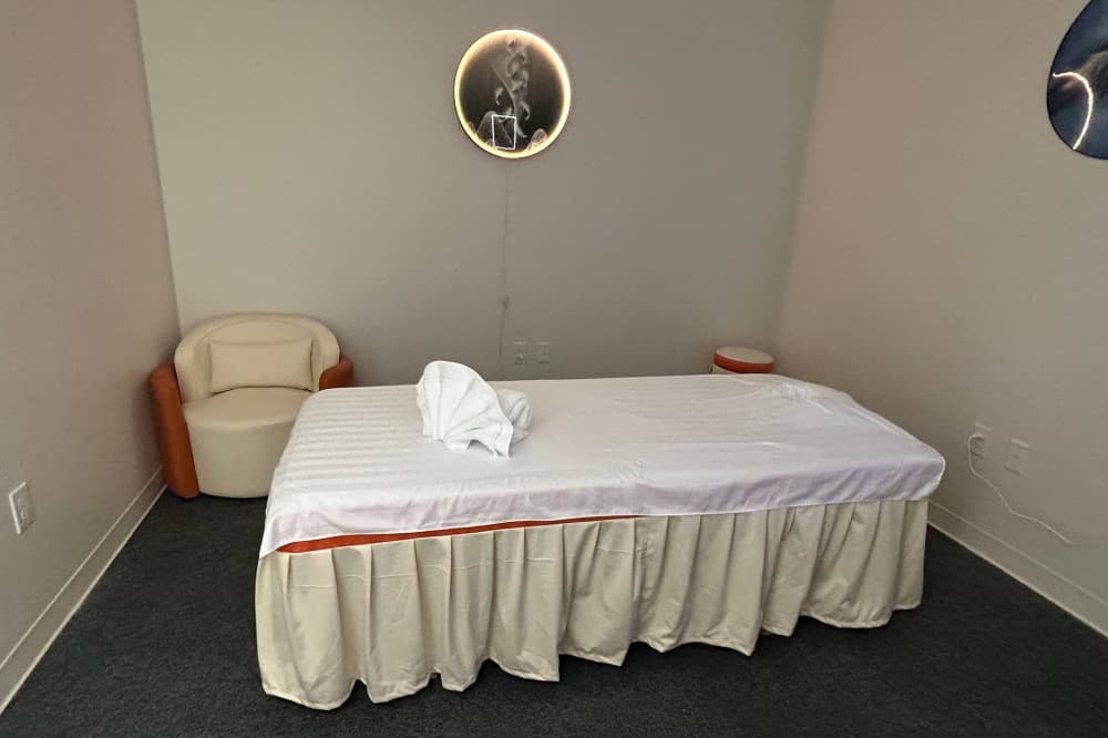 Massage table in a dimly lit room. 