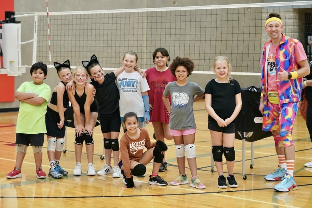 kids in front of a volleyball net
