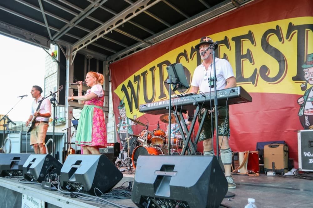 Performers take the stage at Wurstfest 2025, which hosted an additional 30 hours of music. (Ethan Thomas/Community Impact)