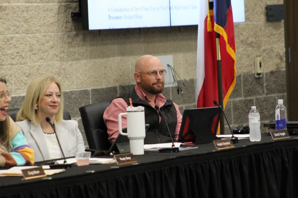 people sit at a table at a board meeting