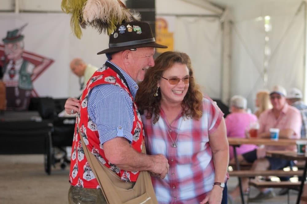Marie Kowalenko hugs the "Grosse Opa" Randy Rust at Wurstfest. (Amira Van Leeuwen/Community Impact)