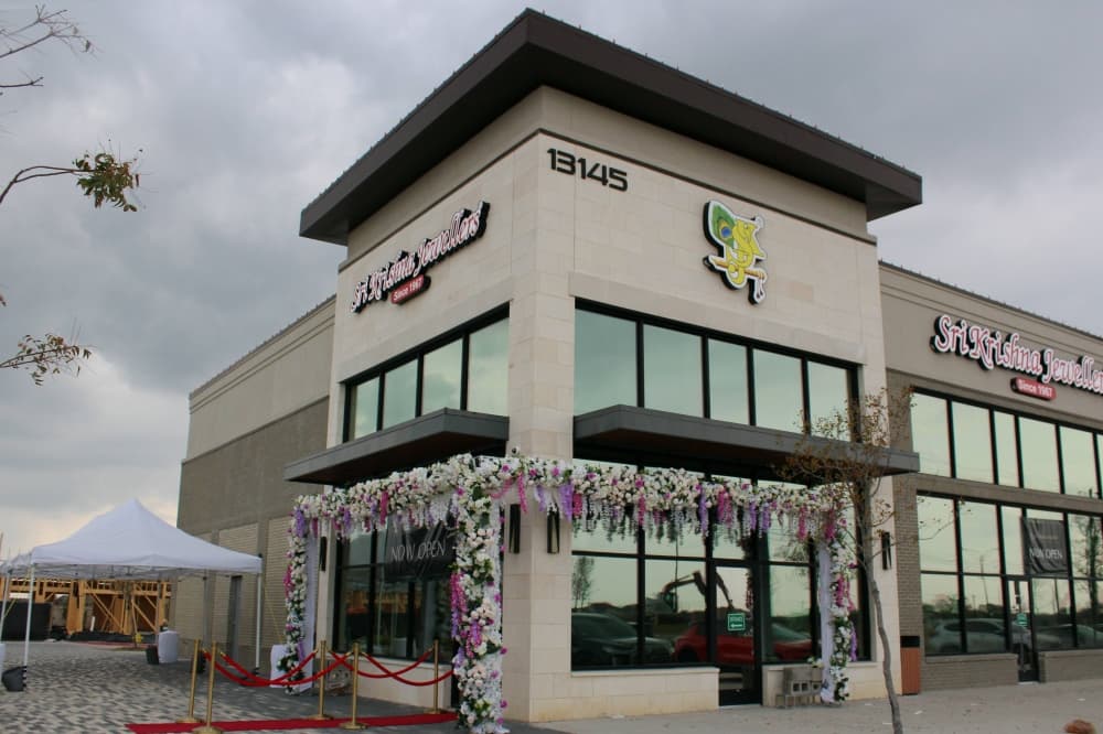 Exterior of a corner spaces in a strip mall featuring Sri Krishna Jewellers signage