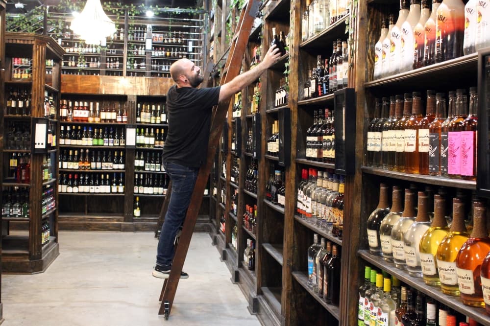 Firewater Operations Manager Michael Montgomery stocks shelves in the McKinney store located at 6351 Eldorado Parkway