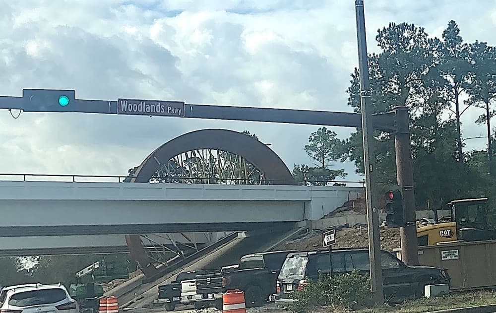 wheel-shaped sculpture by overpass