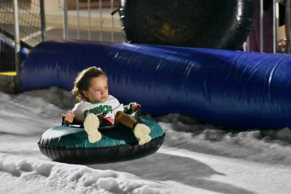 kid on a snow tube 