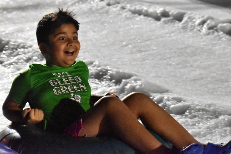 kid going down a snow hill 