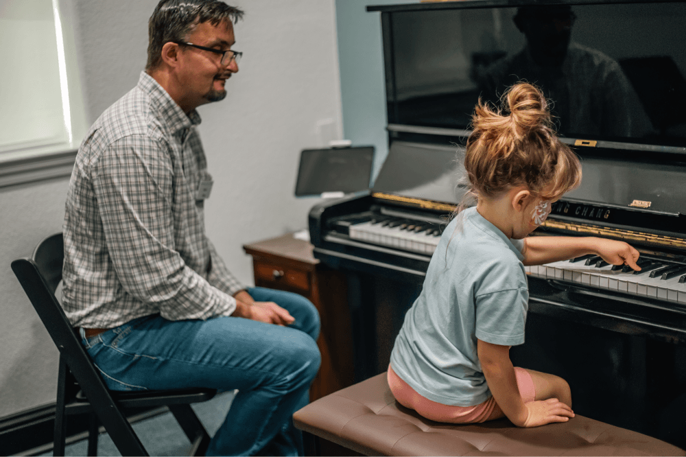 Students performing at a Magnolia recital hosted by Leading Note Studios, showcasing skills in piano, guitar, choir, and musical theater while engaging the local community.