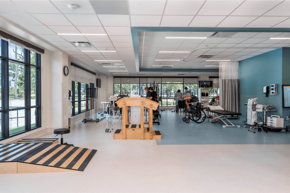 Bright, spacious therapy gym at Exalt Health Rehabilitation Hospital featuring state-of-the-art equipment for inpatient rehab, stroke recovery, amputation rehabilitation, and intensive physical therapy programs.