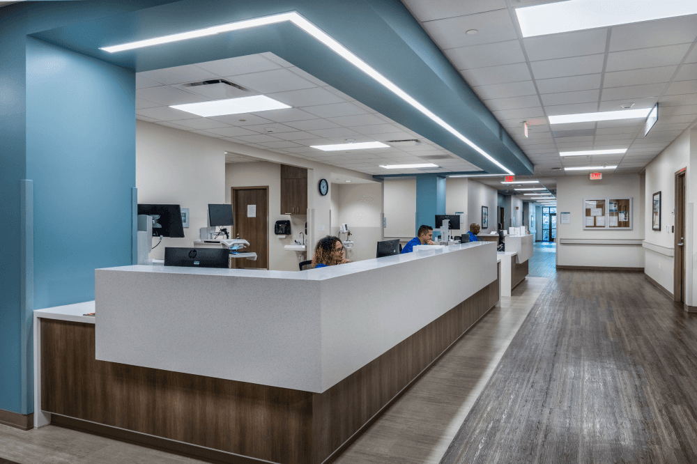 Wide, accessible hallways and floor-to-ceiling windows at Exalt Health in Conroe, creating a safe, supportive environment for patients undergoing intensive inpatient rehab and daily therapy sessions.