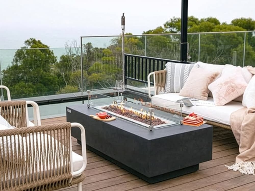 Contemporary patio seating arranged around a minimalist fire feature.