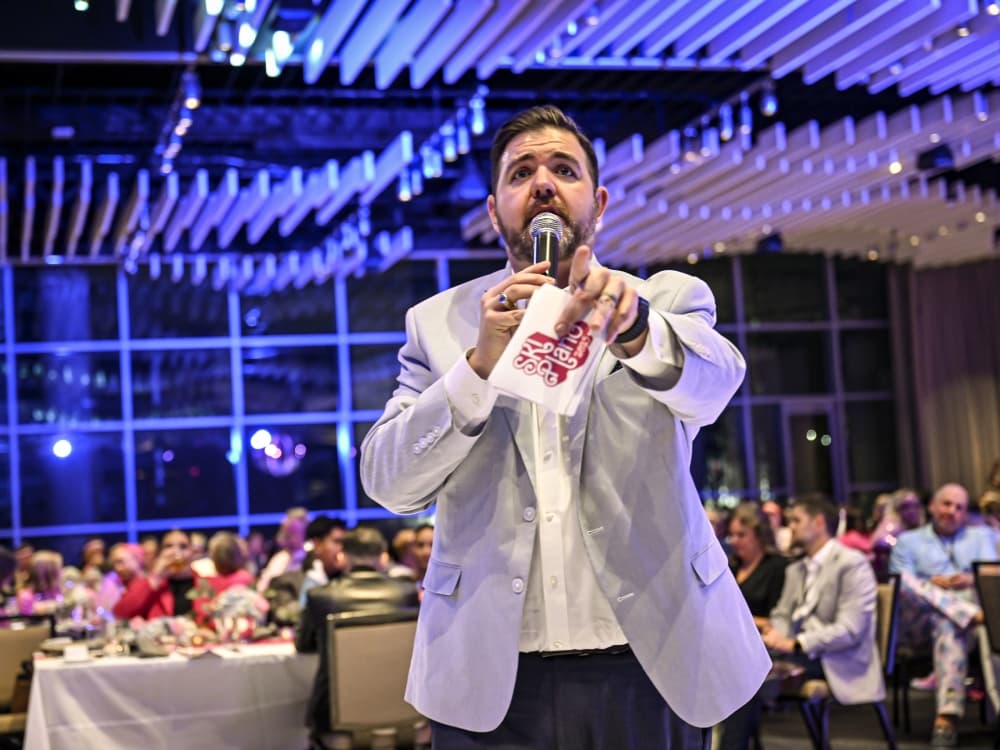 A live auctioneer energizes the crowd during the SKI Plano fundraiser, helping raise vital support for Plano ISD programs.