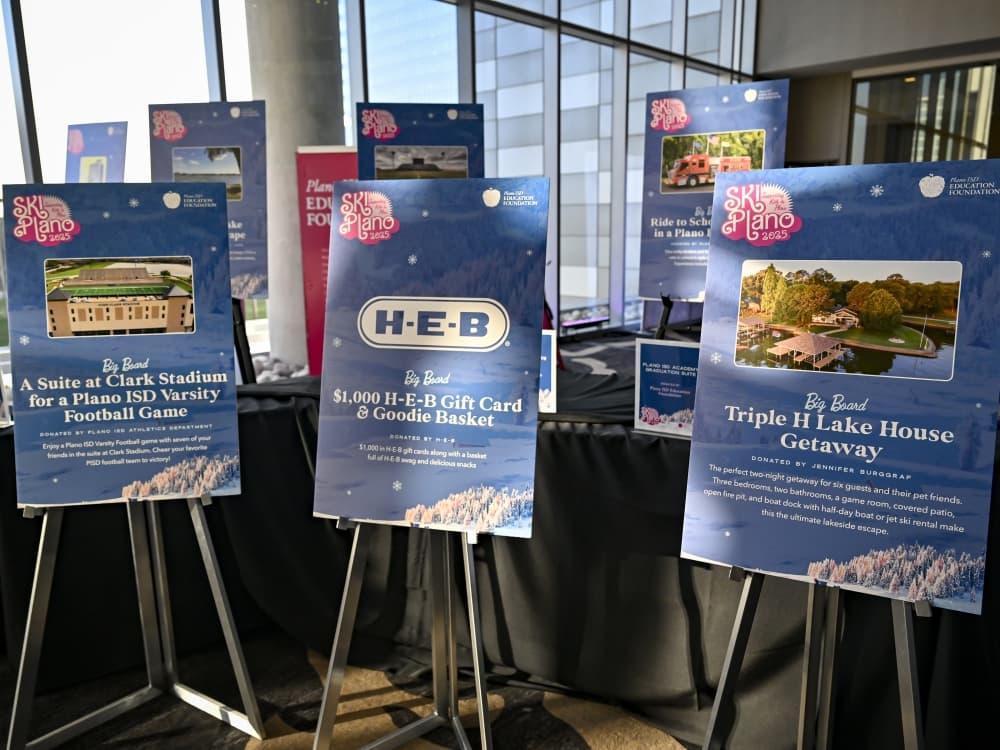 Big Board auction items on display at SKI Plano, featuring exclusive experiences and high-value packages supporting Plano ISD programs.