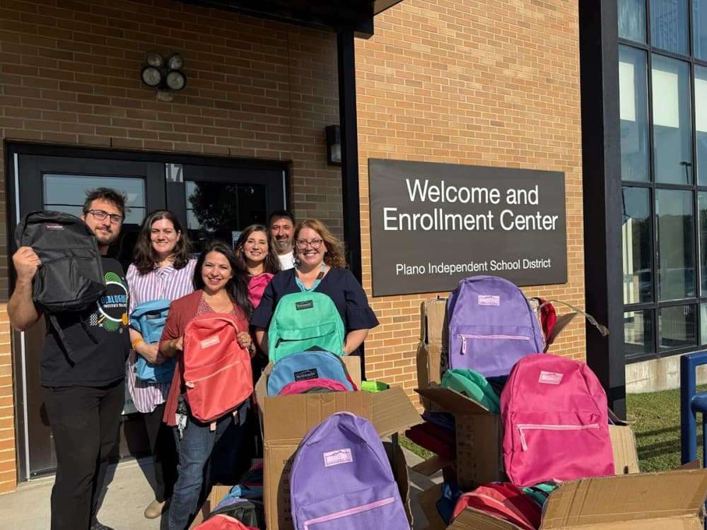 Staff and volunteers at the Plano ISD Welcome and Enrollment Center distribute backpacks to support families preparing for the school year.