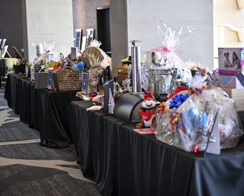 A selection of silent auction items awaits bidders at SKI Plano, helping raise essential funds for Plano ISD students and teachers.