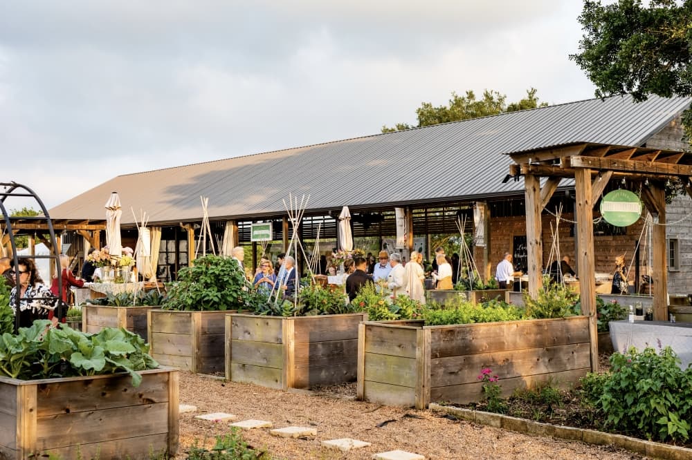 an outdoor pavilion surrounded by planters 
