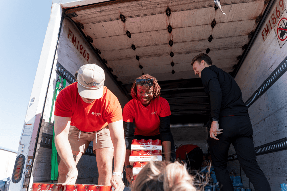 Volunteers at Milestone Church preparing Thanksgiving food drive donations to support Title I schools and North Texas families