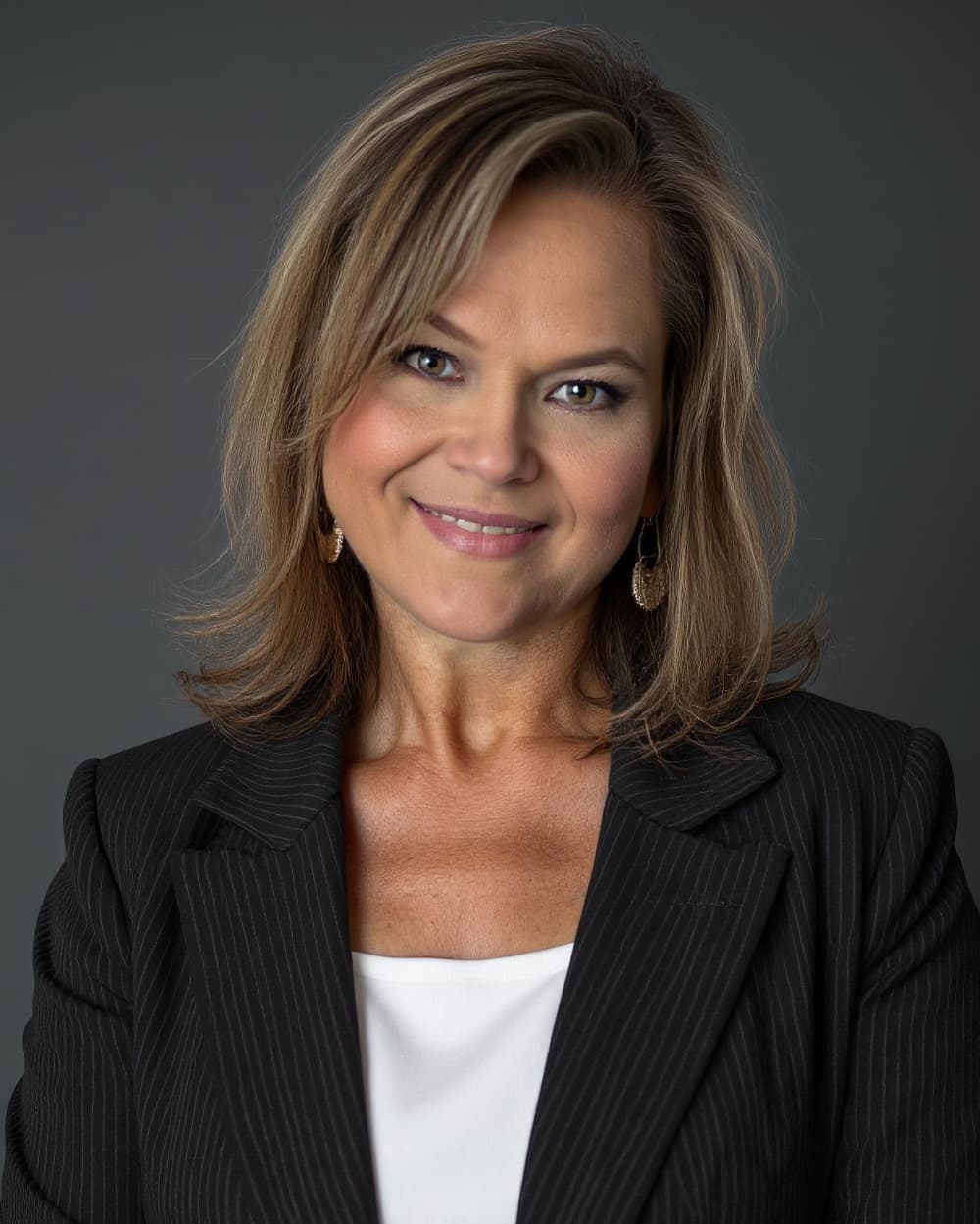 portrait headshot of a woman in a black blazer